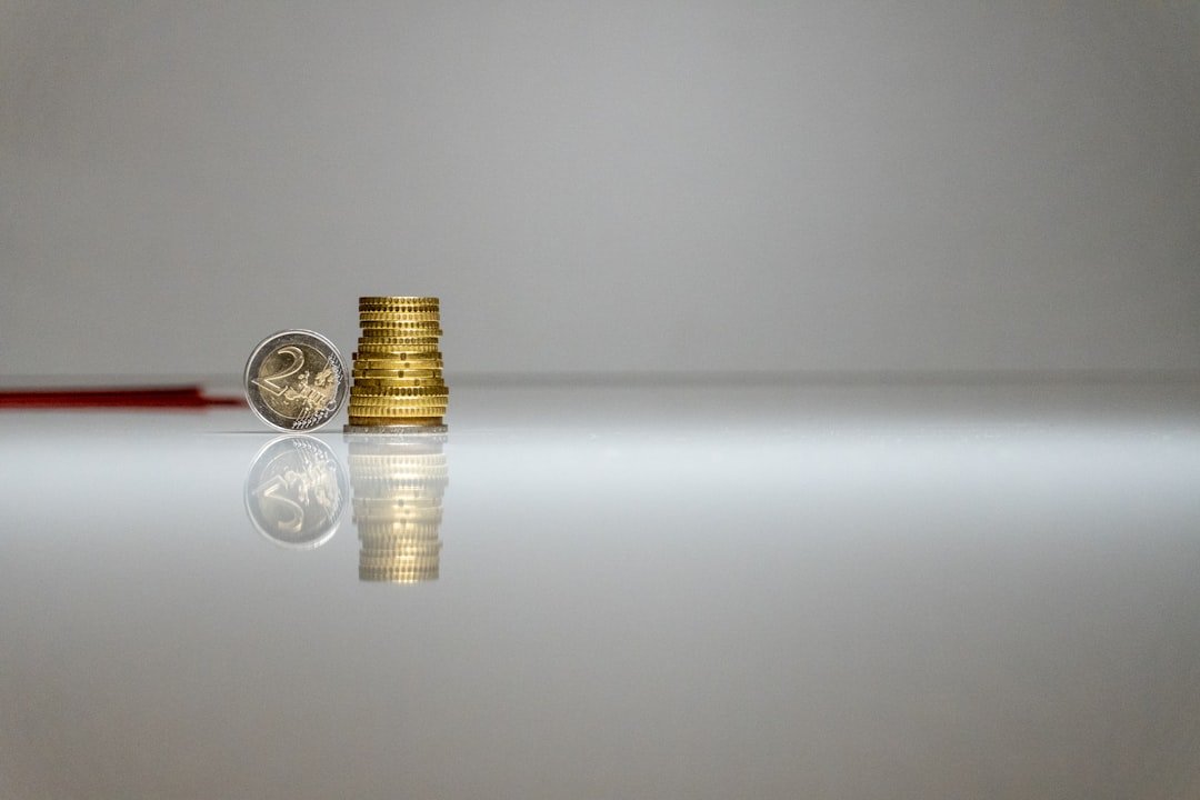a-stack-of-coins-sitting-on-top-of-a-table-jpc-hiafzii